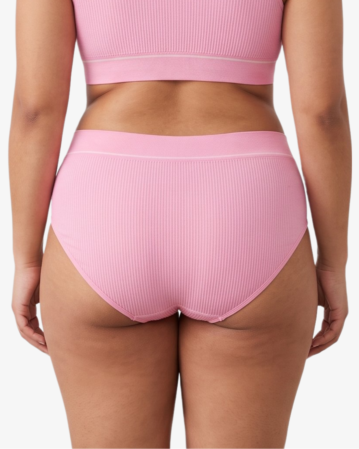 A woman modeling a ribbed high-waisted bikini against a light gray studio background.