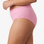 A woman modeling a ribbed high-waisted bikini against a light gray studio background.