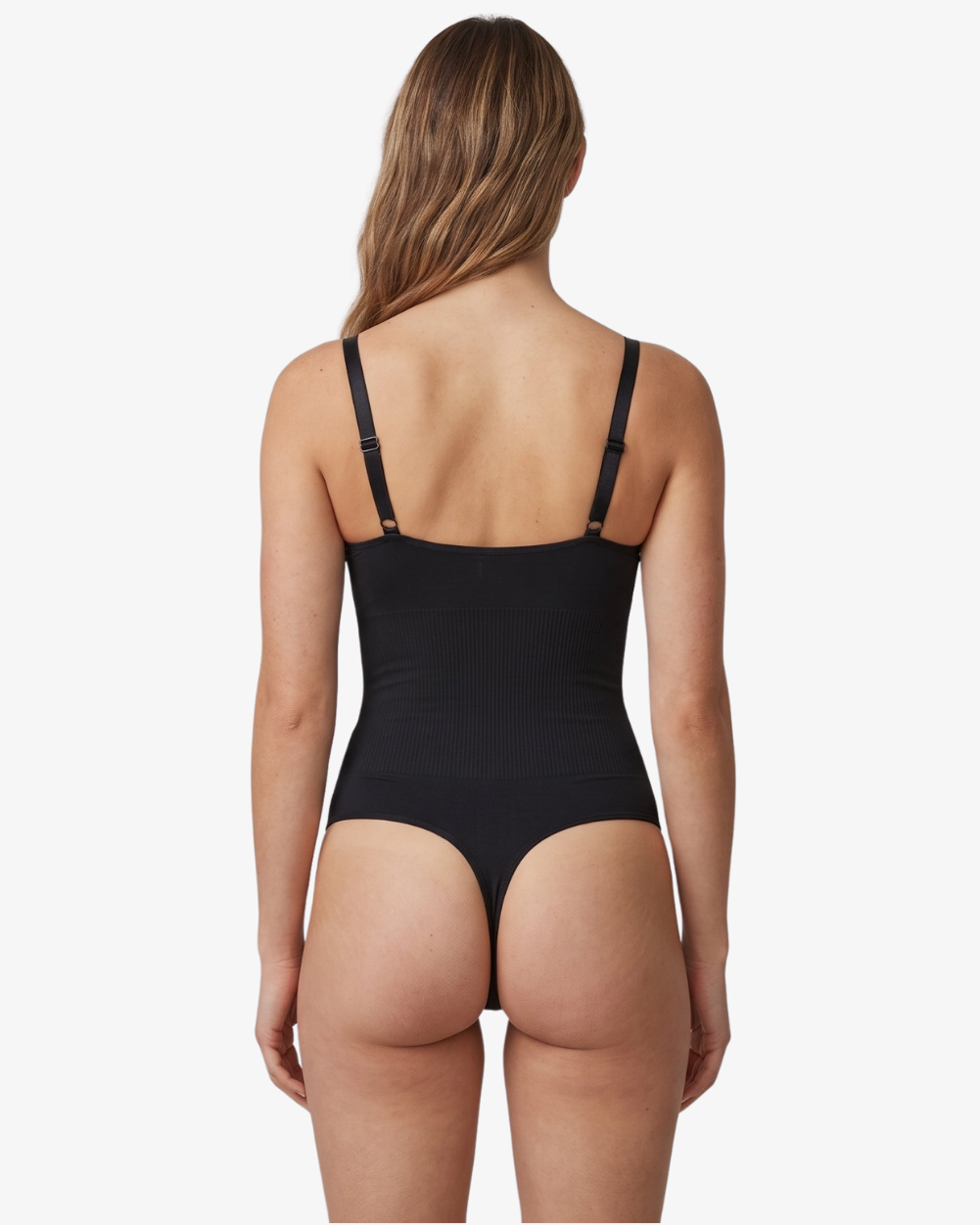 Rear view of a model wearing a black shapewear bodysuit with adjustable shoulder straps, set against a plain light gray background.
