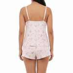 Woman wearing a pink floral pajama set on a white background