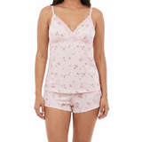 Woman wearing a pink floral pajama set on a white background