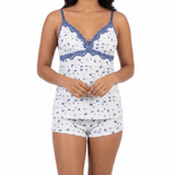 Woman wearing a white and blue patterned pajama set on a white background