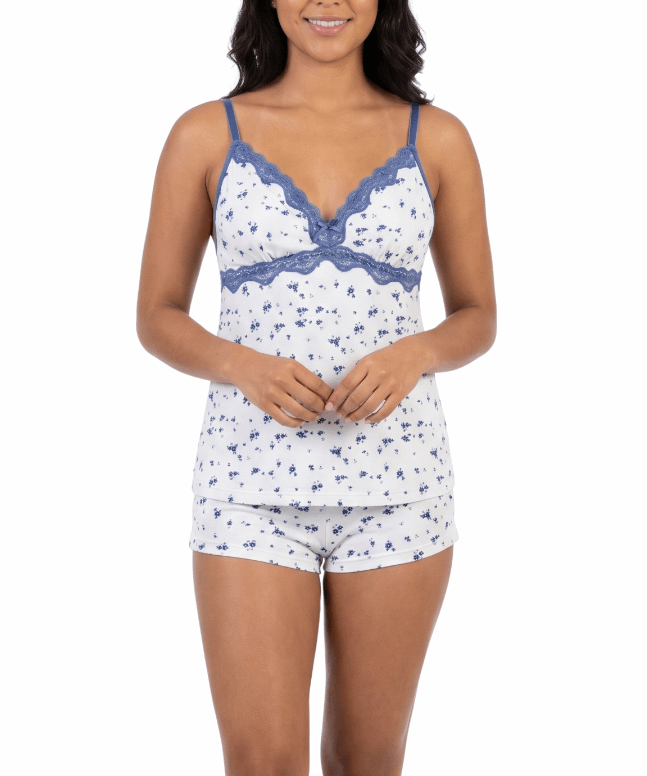 Woman wearing a white and blue patterned pajama set on a white background