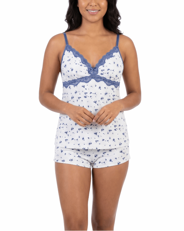 Woman wearing a white and blue patterned pajama set on a white background