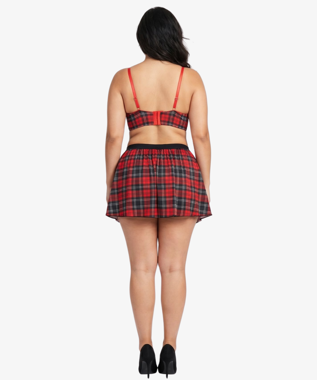 Plus size woman wearing a red and black plaid top and skirt on a white background