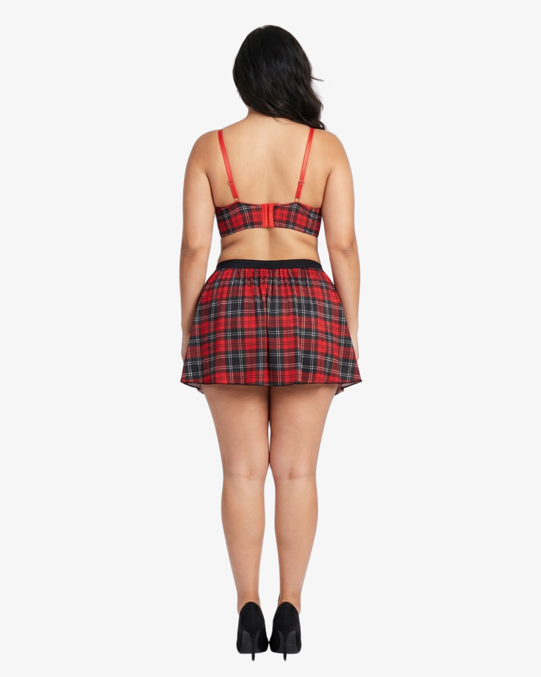 Plus size woman wearing a red and black plaid top and skirt on a white background