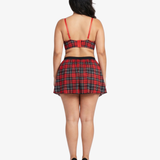 Plus size woman wearing a red and black plaid top and skirt on a white background