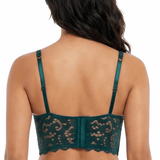 Woman wearing a green lace bra on a white background
