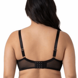 Woman wearing a black lace bra on a white background