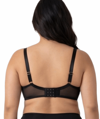 Woman wearing a black lace bra on a white background