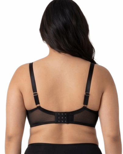 Woman wearing a black lace bra on a white background