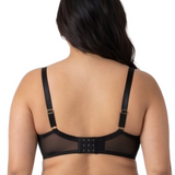 Woman wearing a black lace bra on a white background