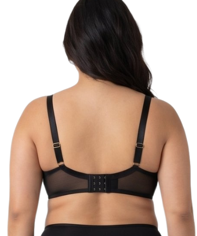 Woman wearing a black lace bra on a white background