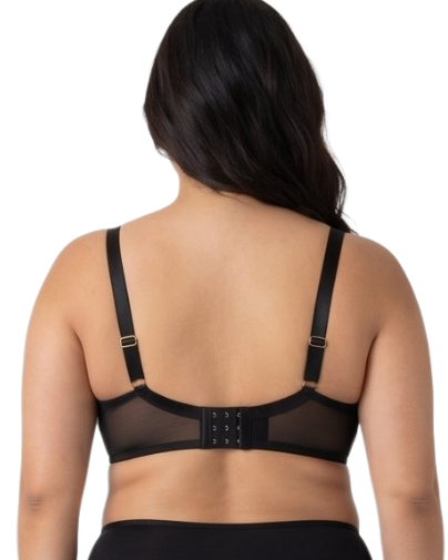 Woman wearing a black lace bra on a white background