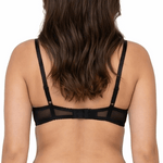 Woman wearing a black lace bra on a white background