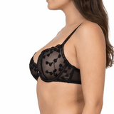 Woman wearing a black lace bra on a white background
