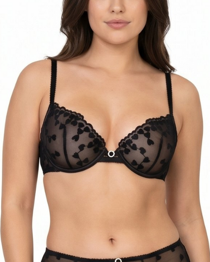 Woman wearing a black lace bra on a white background