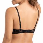 Woman wearing a black lace bra on a white background