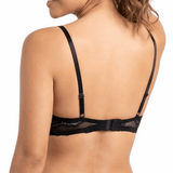 Woman wearing a black lace bra on a white background