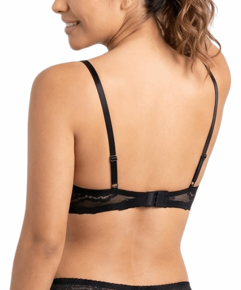 Woman wearing a black lace bra on a white background