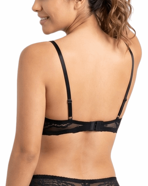 Woman wearing a black lace bra on a white background