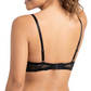 Woman wearing a black lace bra on a white background