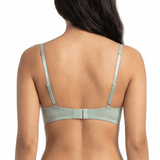 Woman wearing a light green bra on a white background
