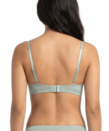 Woman wearing a light green bra on a white background