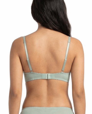 Woman wearing a light green bra on a white background
