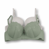 Green bra with lace details and solid white bra on a white background