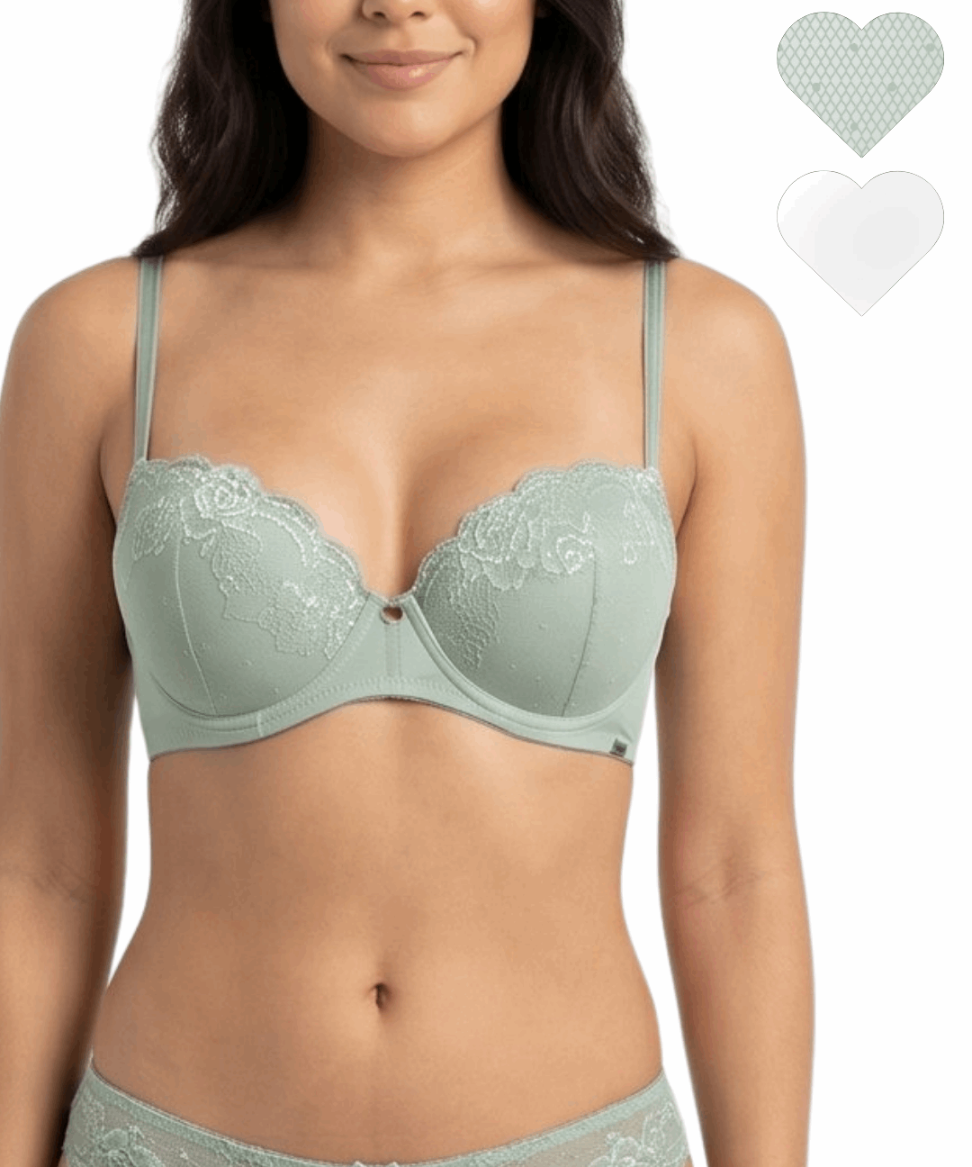 Woman wearing a light green bra and panties set with heart-shaped tags on a white background