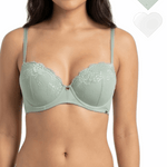 Woman wearing a light green bra and panties set with heart-shaped tags on a white background