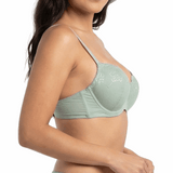 Woman wearing a light green bra on a white background