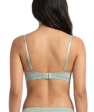 Woman wearing a light green bra on a white background