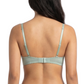 Woman wearing a light green bra on a white background