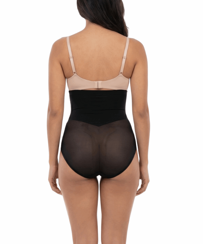 Woman wearing a black shapewear on a white background