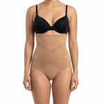 Woman wearing a black bra and mocha shapewear on a white background