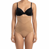 Woman wearing a black bra and mocha shapewear on a white background
