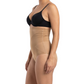 Woman wearing a black bra and mocha shapewear on a white background