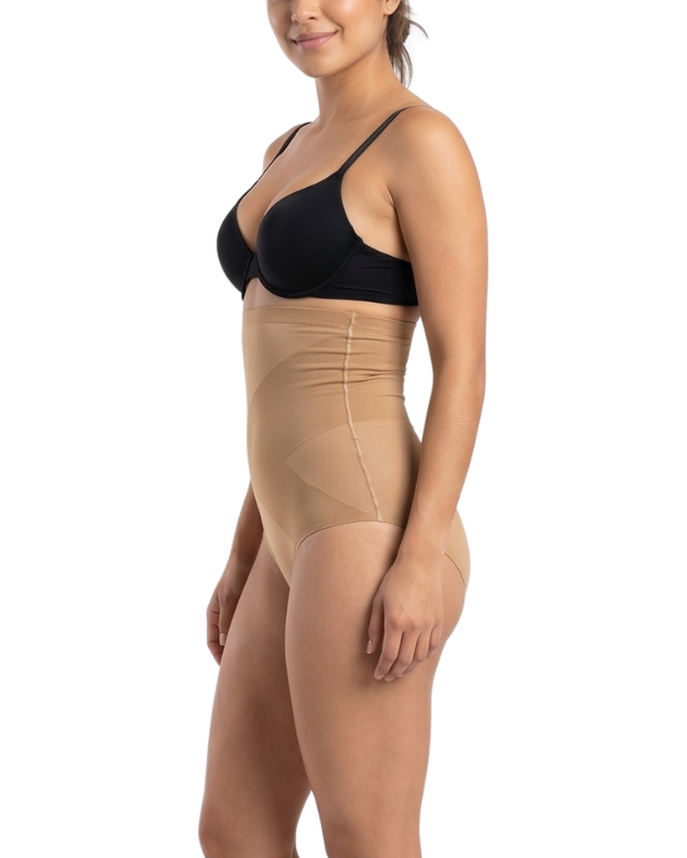 Woman wearing a black bra and mocha shapewear on a white background