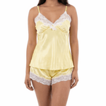 Woman wearing a yellow satin nightgown with lace trim on a white background