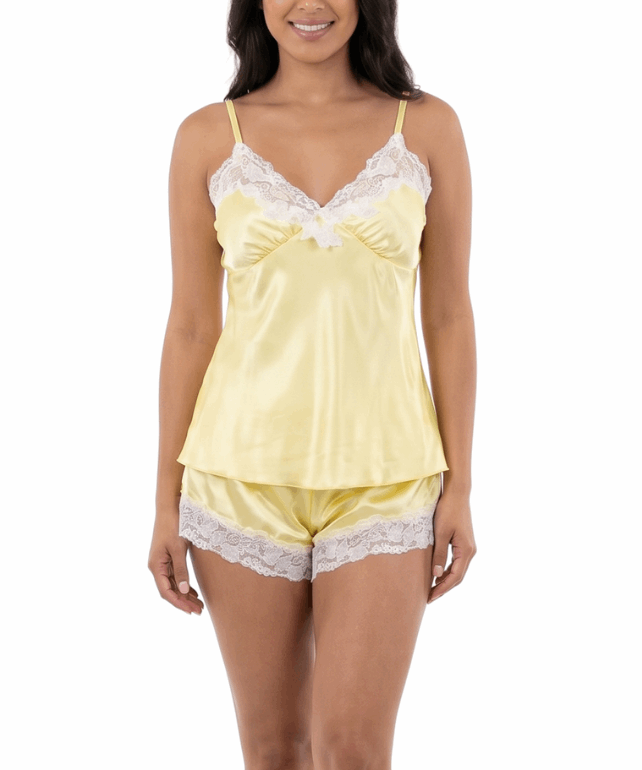 Woman wearing a yellow satin nightgown with lace trim on a white background