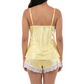 Woman wearing a yellow satin nightgown with lace trim on a white background