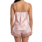 Woman wearing a pink satin nightgown on a white background