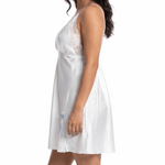Woman wearing a white satin nightgown on a white background